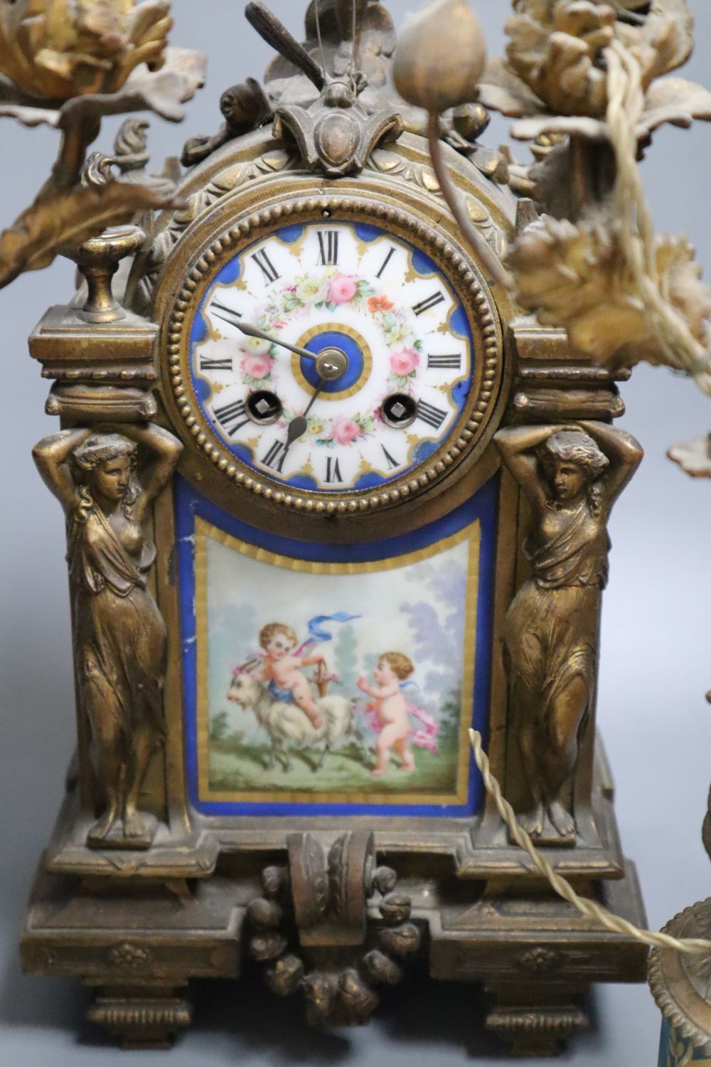 A 19th century French ormolu and Sèvres style porcelain matched garniture de cheminée